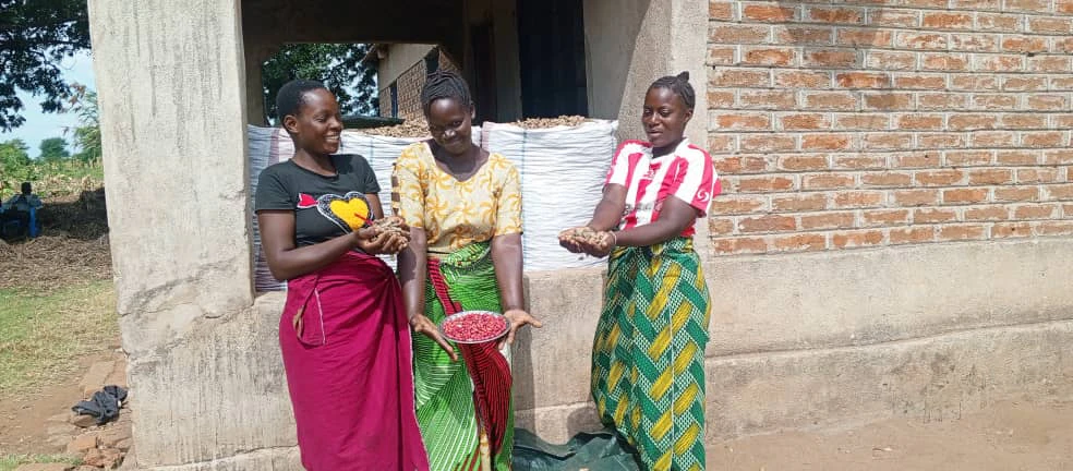 women show off their crops while smiling at each other and towards the camera